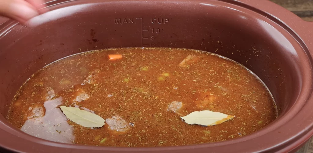 adding the bay leaves to the beef stew